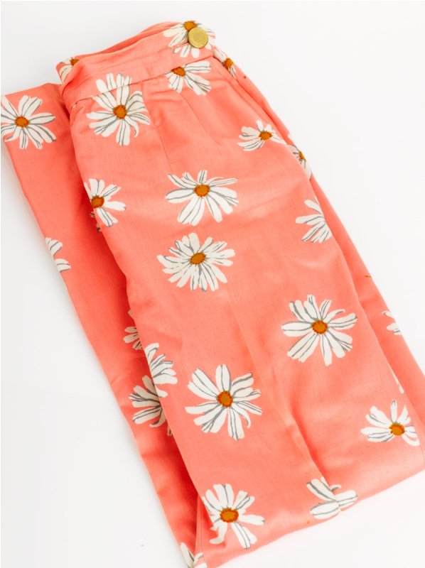 Moschino Pale Pink Daisy Pants: Moschino Pale Pink Daisy Pants of side zip closure design, labelled 'Cheap and Chic' by Moschino, together with Black Leather Skirt with pleated hem detailing, side zip closure, labelled Moschino 'Che