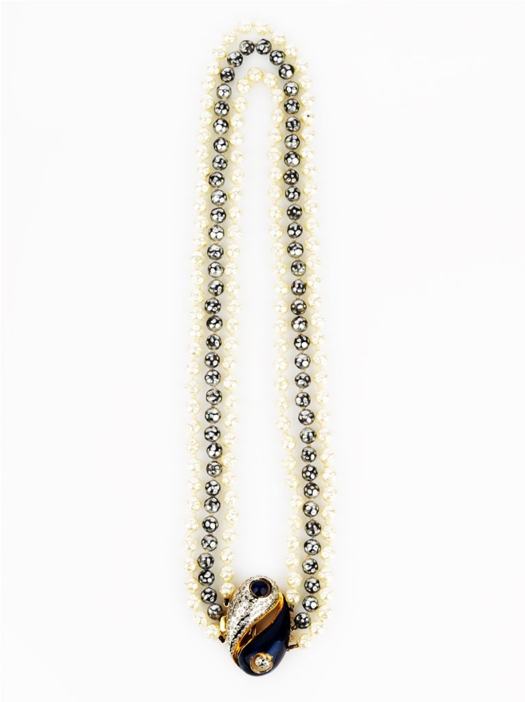 Pierre Cardin, Faux Pearl Necklace: Pierre Cardin, Faux Pearl Necklace consisting of two white and one black faux pearl strands with a blue enamel and paste set clasp, signed 'Pierre Cardin'