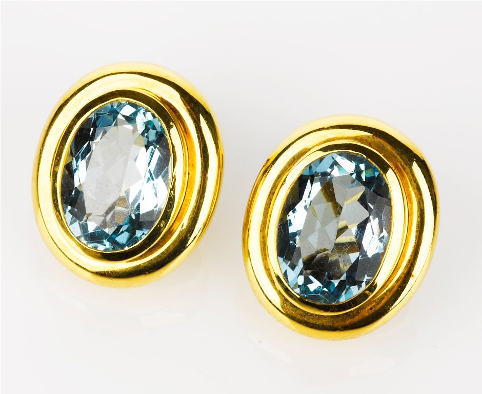 Paloma Picasso for Tiffany and Co., Pair of Earring: 18ct yellow gold oval earclips, each containing a blue topaz, signed 'Paloma Picasso, Tiffany & Co.' (2) total weight 14 grams