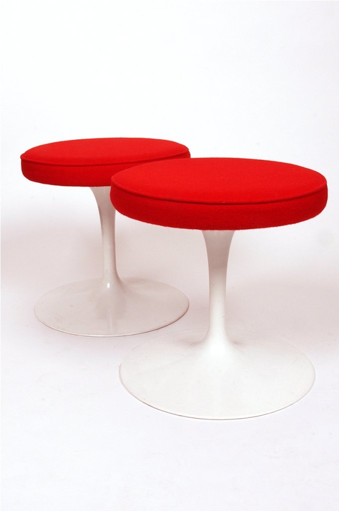Eero Saarinen, Pair of Tulip Stools: manufactured by Knoll International, red upholstered seat cushions, retains paper label 'William Latchford and Sons Pty Ltd, Knoll International' each height 40 cm width 40 cm (2)