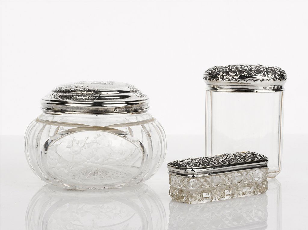 Henry Mathews, Birmingham 1898, Three Dressing Table Ja: Henry Mathews, Birmingham 1898, Three Dressing Table Jars crystal jar, sterling silver lid floral decoration, together with a cut crystal jar, sterling silver foliate decorated lid, Adie and Lovekin L