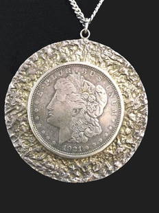 FRAMED 1921 MORGAN HEAD SILVER DOLLAR ON CHAIN APPROX.: FRAMED 1921 MORGAN HEAD SILVER DOLLAR ON CHAIN APPROX. 46.6 DWT