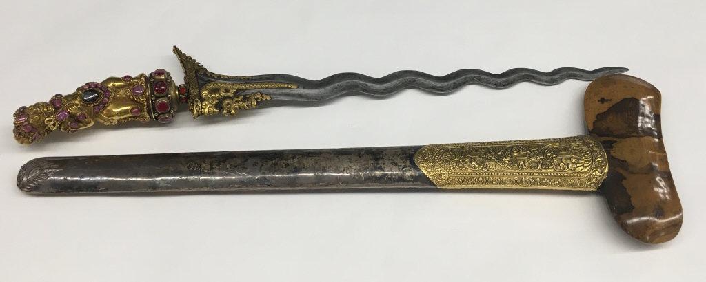 BALINESE KRIS W/ HEAVY GOLD FIGURE OF DEMON RAKSHA: HANDLE W/ LOCAL RUBIES & SAPPHIRE, THE MENDAK IS GOLD W/ RUBIES RONKO & PENDOK RAREWOOD COVERED IN GOLD & SILVER W/ WAVY BLADE W/ GOLD INLAY @ NAGA FITTED CASE (27" LONG)