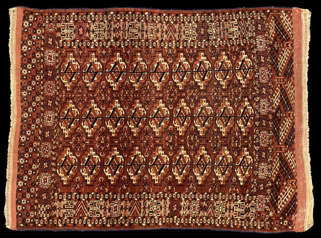 TURKOMEN AREA RUG C. 1910, FINISHED W/ RINGS FOR: TURKOMEN AREA RUG C. 1910, FINISHED W/ RINGS FOR HANGING (53" X 38 1/2" )