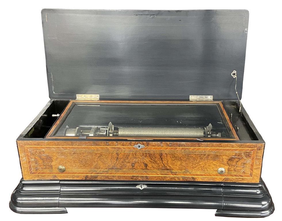 WALNUT INLAID DOUBLE COMB CYLINDER MUSIC BOX W/ 2 INTERCHANGABLE CYLINDERS, VENEER DAMAGE (11 1/2": WALNUT INLAID DOUBLE COMB CYLINDER MUSIC BOX W/ 2 INTERCHANGABLE CYLINDERS, VENEER DAMAGE (11 1/2" TALL X 36" WIDE X 18 1/4" DEEP)