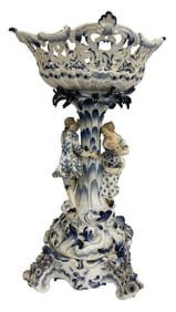 MEISSEN CENTERPIECE WITH BASKET ABOVE 2 FIGURES BASKET : 14" X 11 1/2" X 19 1/4" TALL OVERALL