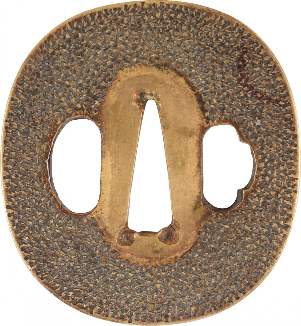 JAPANESE SWORD GUARD TSUBA: Brass, oval form, 2 3/8" height. Two riobitsu. Both sides are decorated with a punched matrix. The back plain. Surface textured.