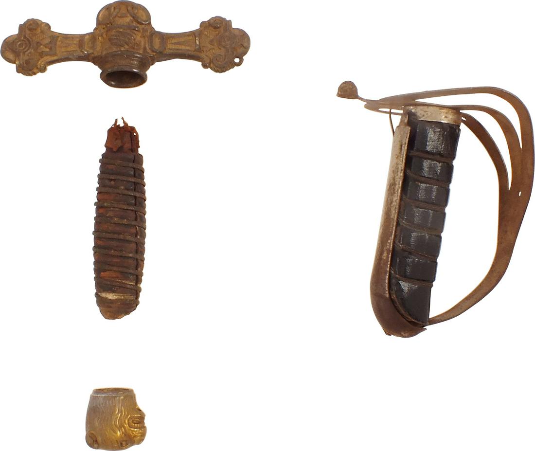 SWORD PARTS: A cruciform sword guard, a lion head pommel for an English officer's sword, the hilt of an Indian sword, and a sword grip. Various dates.