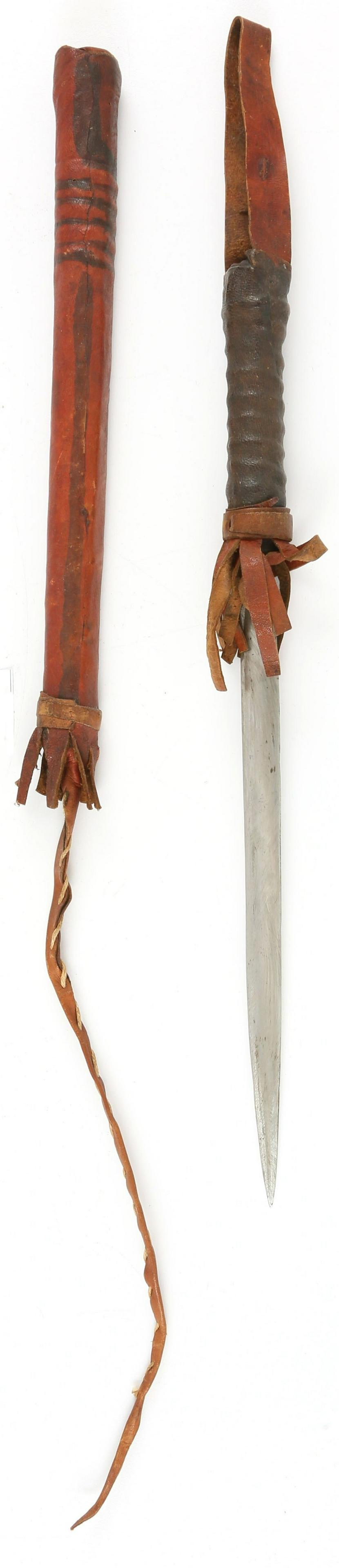 TAUREG CONCEALED DAGGER QUIRT: 30" total length. The grip and body covered in reds and black stained leather as found on the broadsword takoba. The grip with a leather wrist loop and the tip with a rudimentary "whip". 9 1/2" concea