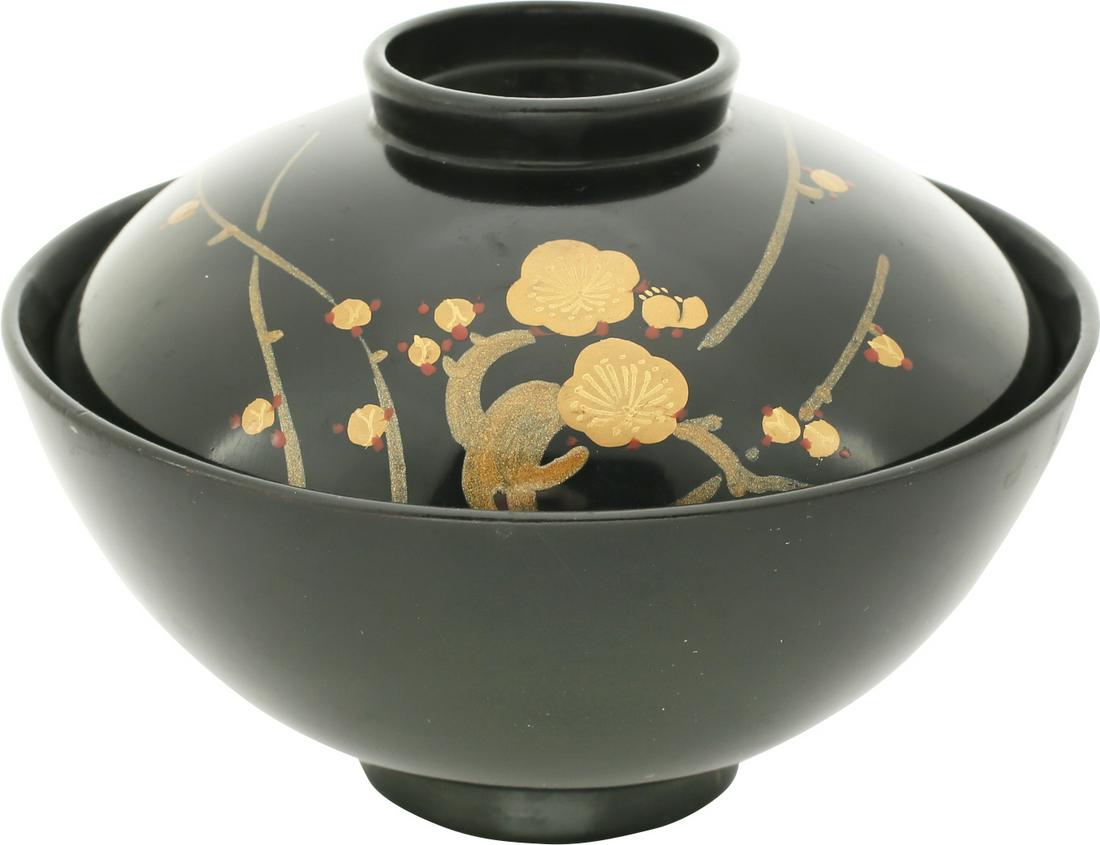 JAPANESE LACQUER BOWL AND COVER, 19TH CENTURY: 19th century. Good quality earlier example. 4 5/8" diameter with a wl of deeply dished profile. Both black lacquered. The top with green shoots, and flower bud executed in shades of pure gold. Clearly