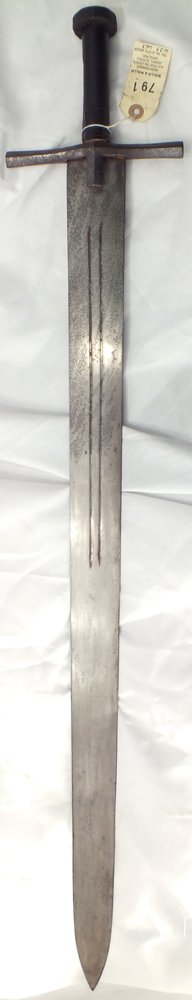 A SUDANESE KASKARA SWORD War of 1885: 33 5/8" broad blade with two fullers. Hide covered grip. Type associated with the Mad Mahti and the Sudanese War of 1885. Old auction tag attached.