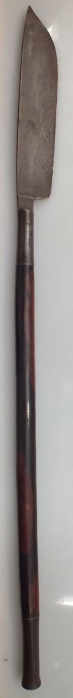 RARE NORTH INDIAN BHUJ 17TH CENTURY: 17th century. 34 1/8" overall with straight edged blade used for thrusting and slashing. Hard wood haft with flared iron terminal. Head with dark patina and pitted. A very rare early parrying weapon.
