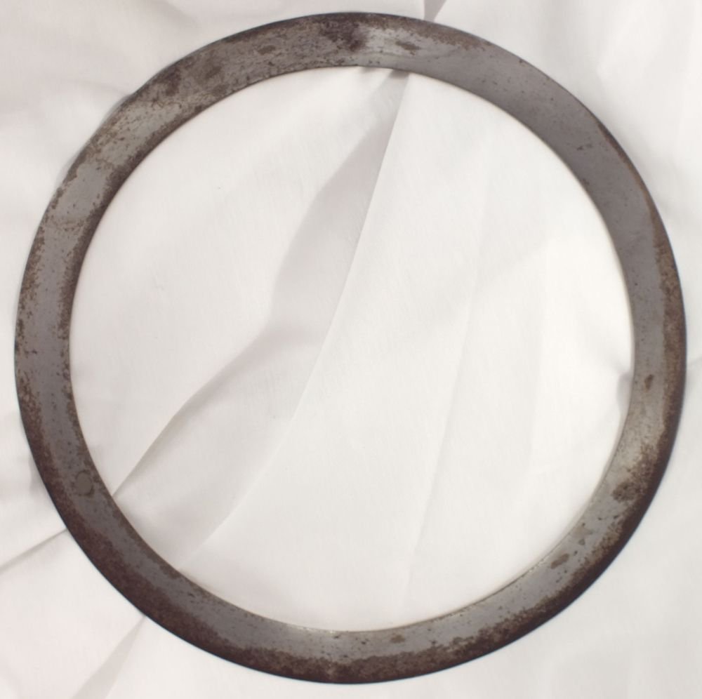 INDIAN SIKH CHAKRAM THROWING RING: The throwing ring of the Sikhs. Iron. 9 3/16" diameter. Watered steel patterning evident. 9 5/16" diameter.