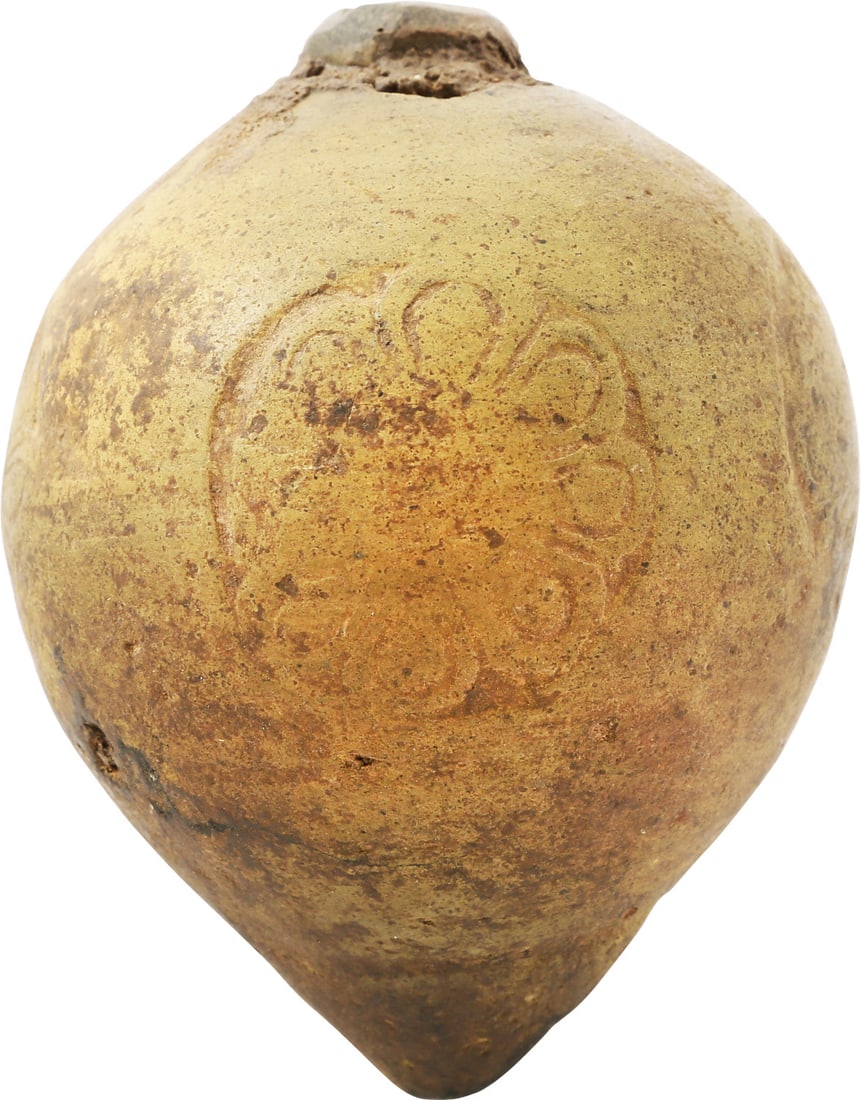 BYZANTINE POTTERY GRENADE, 10TH-12TH CENTURY: Crusades period. 4 1/4" height, polished dark gray terracotta. The body is of turnip form with a stamped decoration of a stylized flower repeated around the perimeter. The top with a low mounded wick.