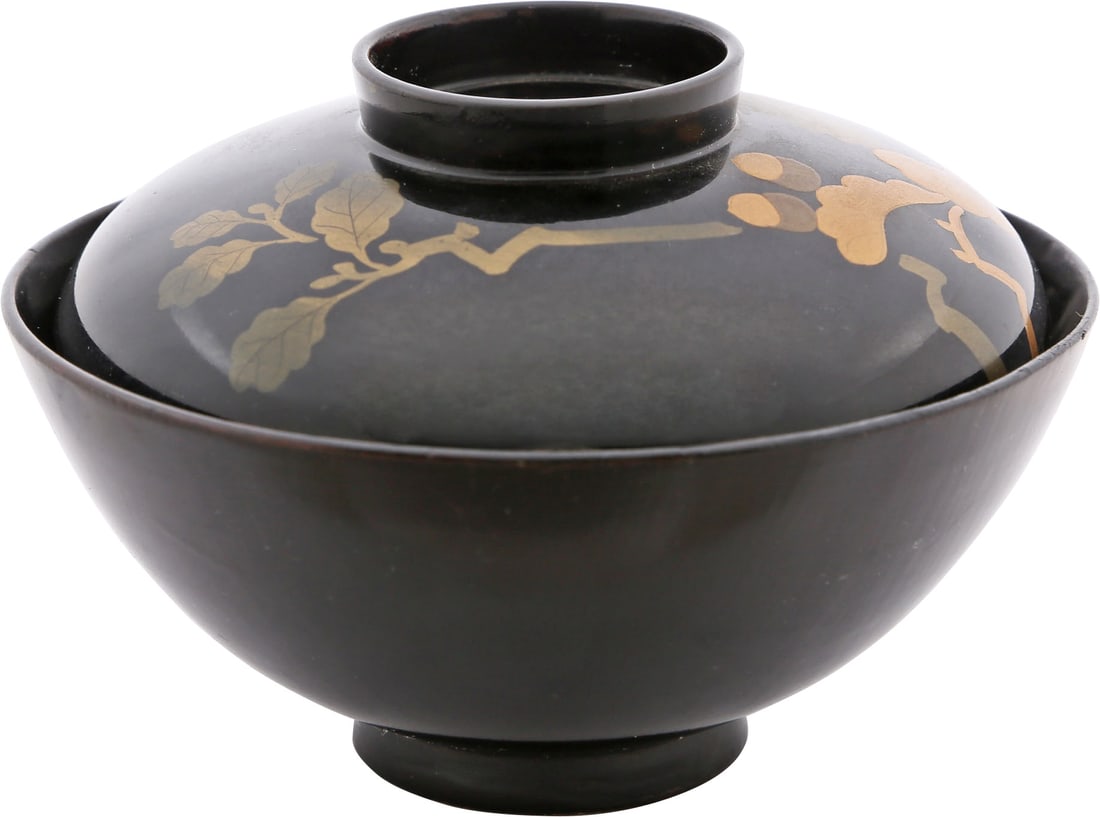 JAPANESE LACQUERED BOWL AND COVER, OWAN: Meiji Period, before 1912. 4 3/4” diameter. Black body color with the well of the bowl deep brown. the lid decorated with oak foliage including two acorns. Oak leaves represent hereditary prospe