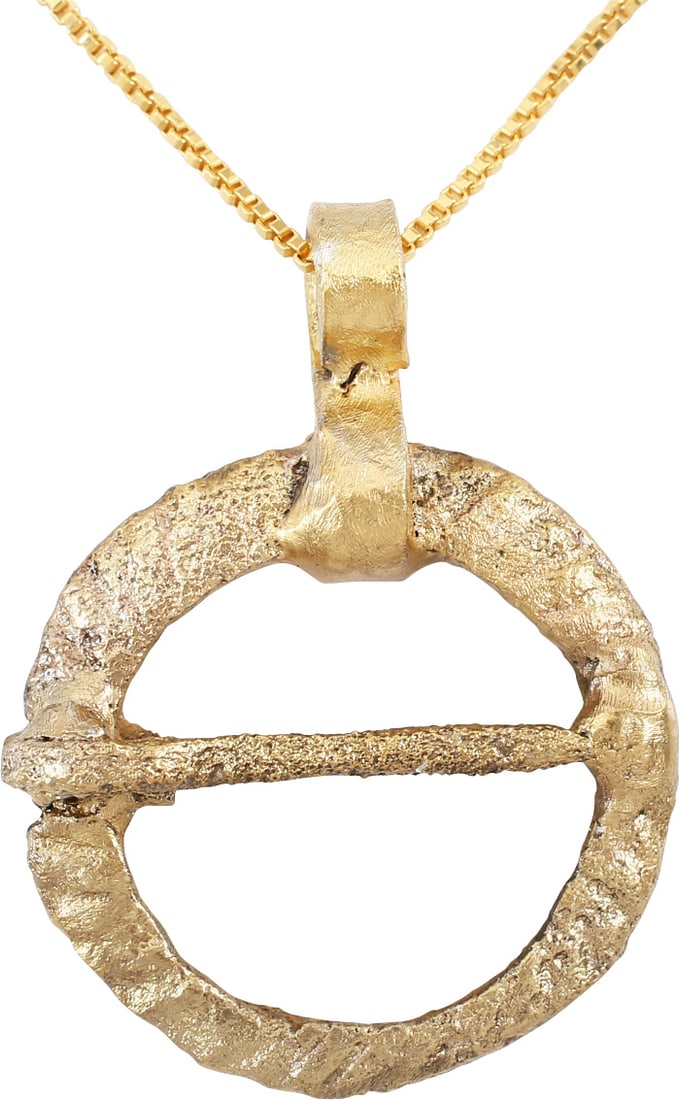 RARE VIKING PROTECTIVE BROOCH NECKLACE, 10th CENTURY: Bronze, 7/8" diameter. Circular with the top wider than then bottom and the front decorated with spiral fluting. The edge inlet to seat the cross pin. The back flat. Worn in multiples attached to leat