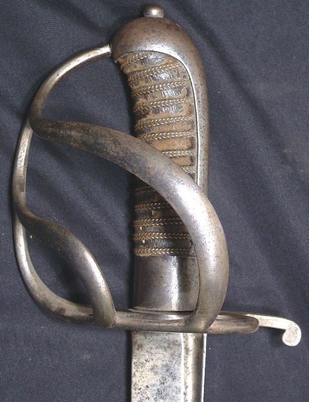 SWISS INFANTRY HANGER C.1760: 5 3/4" curved s.e. narrow fullered blade etched with the bear for Bern Canton. Iron hilt with single loop side guard connected to the knuckle bow with double broad scrolling bars. Integral back strap 