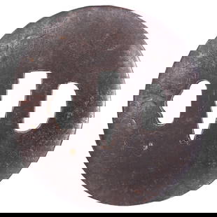 JAPANESE SWORD GUARD TSUBA , EDO BEFORE 1867: Iron, slightly oval. 2.9" o.a. Two riobitsu. Line chiseled in scrolling foliage with traces of copper inlay and piques, balanced by a single chiseled in an oak leaf. Signed both sides of the seppa dai
