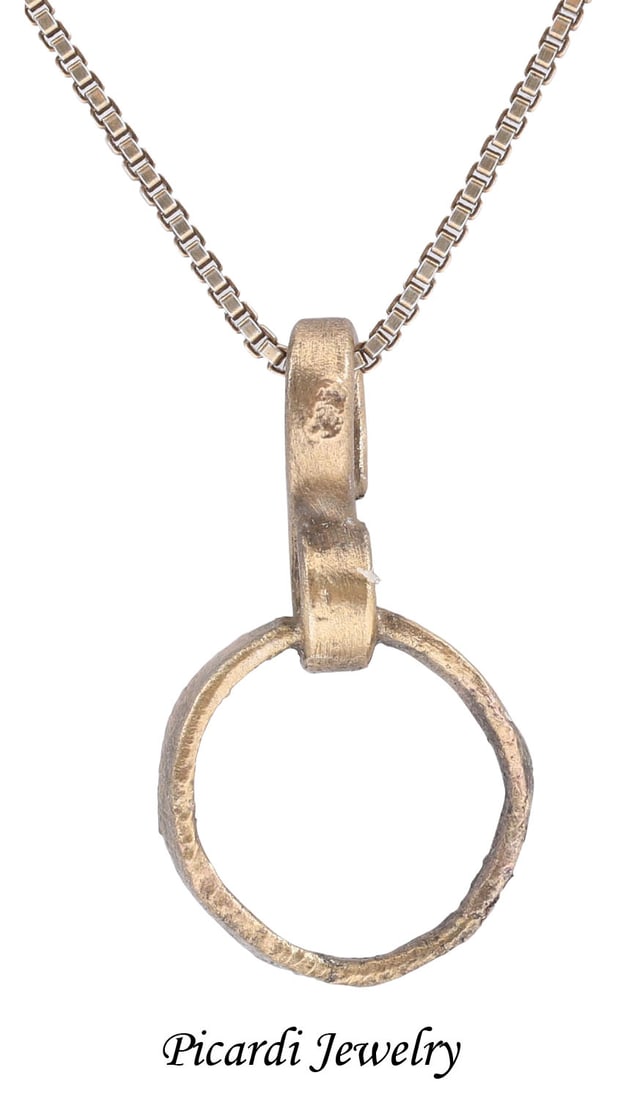 VIKING BEARD RING NECKLACE, 9th-11th CENTURY AD: Round with low rounded face and flat inside, 0.38” inside diameter and 0.45” outside. The use of beard rings by Vikings is well documented though very few genuine examples survive. Surface
