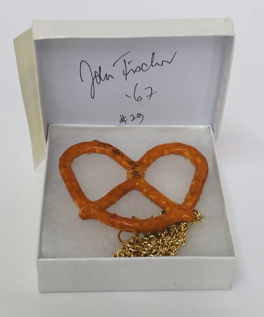 Make Bread Not War John J Fischer Pretzel Necklace: Described By:Nikki HFA 24494CTitle:Make Bread Not War John J Fischer Pretzel NecklaceDescription: John J. Fischer is an American artist born in Belgium in 1930. An artist working in many forms, he fir