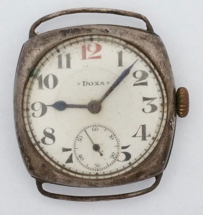 WWI Era Doxa Sterling Silver Trench Watch Mathey Case: Description: WWI Era Doxa Sterling Silver Trench Watch Cushion Shape Orig Mathey Swiss Case Size:31mm wide, 9mm thick, 38mm lug end to end, 22mm lug width Condition:Displays some wear Movement Conditi