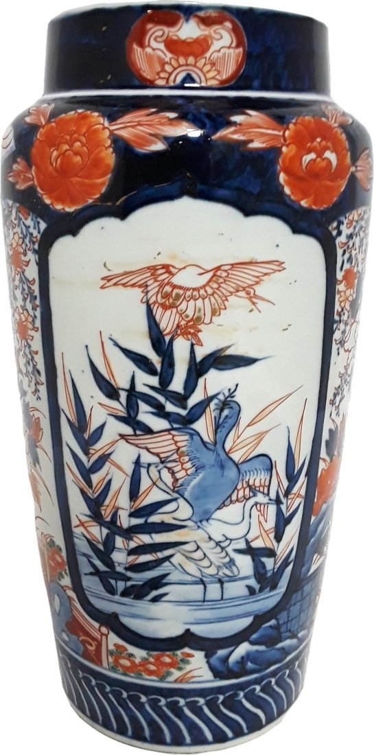 Tall Imari Panel Blue White Red Vase: Described by: Rachel CNX 1208 5019 Title: Tall Imari Panel Blue White Red Vase Description: 3 Squabbling cranes in a pond are in the center of these panels. The rest of this vase has different foliage