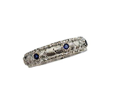 Buccellati Natural Blue Sapphire 18k White Gold Ladies Band Ring: Title:Buccellati Natural Blue Sapphire 18k White Gold Ladies Band Ring Description: Signed Buccellati and set in 18k white gold. Featuring Seven 1.7mm Natural round sapphires totaling approx. 0.24ctw.