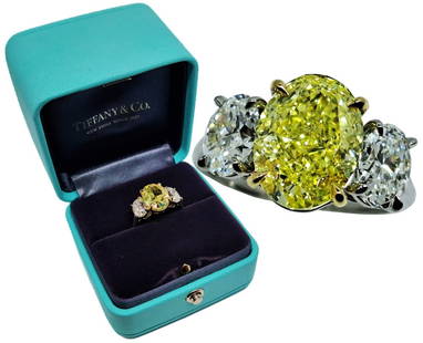 Tiffany 18k Platinum 5ct Fancy Intense Oval Yellow Diamond Ring 400k Retail w/ 2 E Color Sides: Title: Tiffany and Co 18k Platinum 5.02ct Oval Yellow Diamond 3 Stone Ring w/ Valuation Report Description: Tiffany and Co 18k Platinum 5.02ct Oval Yellow Diamond 3 Stone Ring w/ Valuation Report. Ou