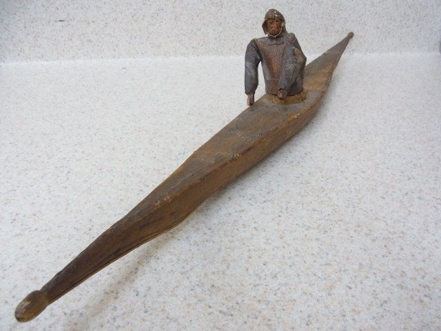 Antique INUIT Miniature Sealskin Kayak with Costume: Antique INUIT Miniature Sealskin Kayak with Costumed Paddler Carved Figure 21-3/4" Bone Detail Native American Indian CNX Great local estate find! Paddle is absent. Measures-3-3/4" high by 21-3/4" lon