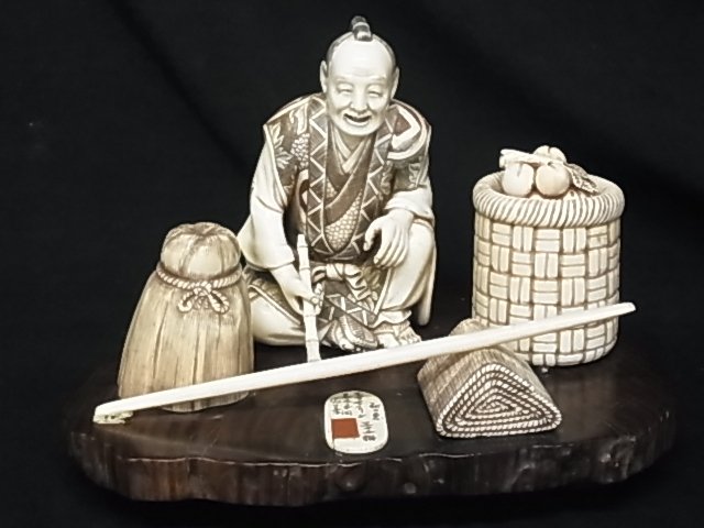 Japanese Carved Ivory Okimono Figure Group w/ Man S: Japanese Carved Ivory Okimono Figure Group w/ Man Smoking Bamboo Pipe Signed & Inscribed Probably Late Meiji or Showa Description: Pristine carving with many varieties of geometric, floral and leaf pa