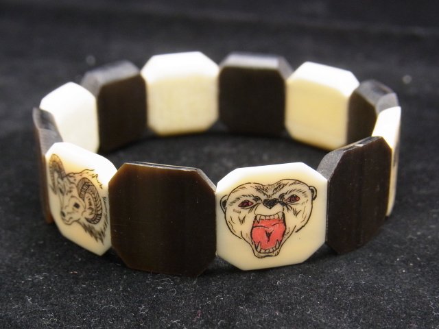 Eskimo Ivory & Horn Scrimshaw Art Moderne Animal B: Eskimo Ivory & Horn Scrimshaw Art Moderne Animal Bracelet Description: Each ivory piece depicts different Northern animals including a hare, wolf, Ram, bear, otter, and goat. Pieces are attached with 