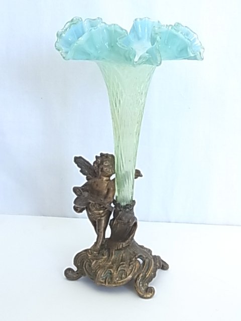 Victorian Opalescent Blue Art Glass Ruffled Rim Epergne: Victorian Opalescent Blue Art Glass Ruffled Rim Epergne Trumpet Vase With Diamond Pattern and Figural Cherub Putto Scrolled Base Approx. Dimensions or Size: Height: 9.50”, Diameter: 5.75” Hess Fin