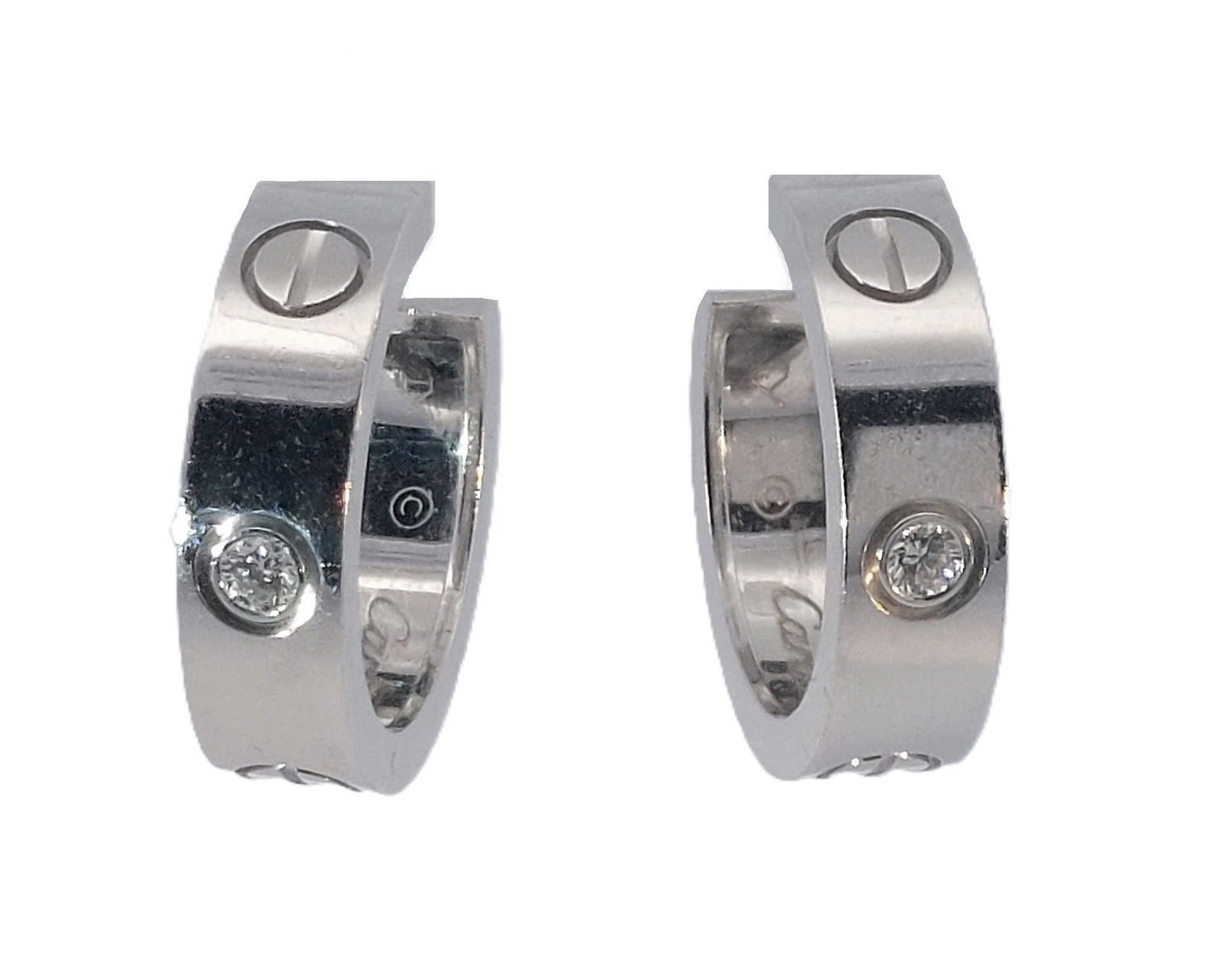 Cartier 18k White Gold Diamond Love Collection Signed Numbered Huggie Hoop Earrings: Title: Cartier 18k White Gold Diamond Love Collection Signed Numbered Huggie Hoop Earrings Description: A classic pair of round hoop earrings made in solid 18k white gold from Cartier’s Love Collec