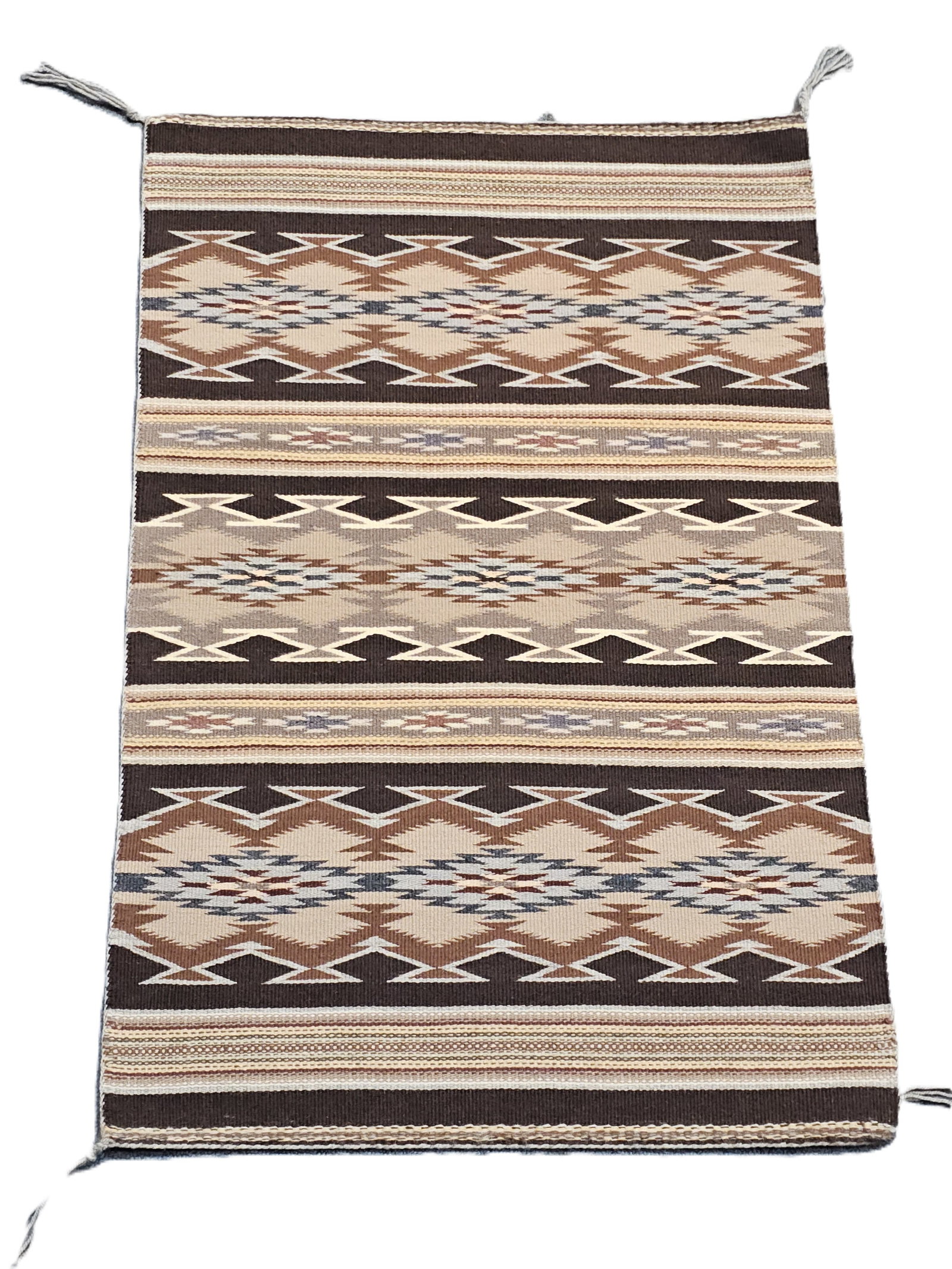 Small Wool Navajo Rug 20x30.5 Sedona Native American Collection: Described By: August Adams ND Title: Small Wool Navajo Rug 20x30.5 Sedona Native American Collection Description: Gorgeous flatwoven wool rug. Brown, gray and tan. Wool with warp woven back in and war