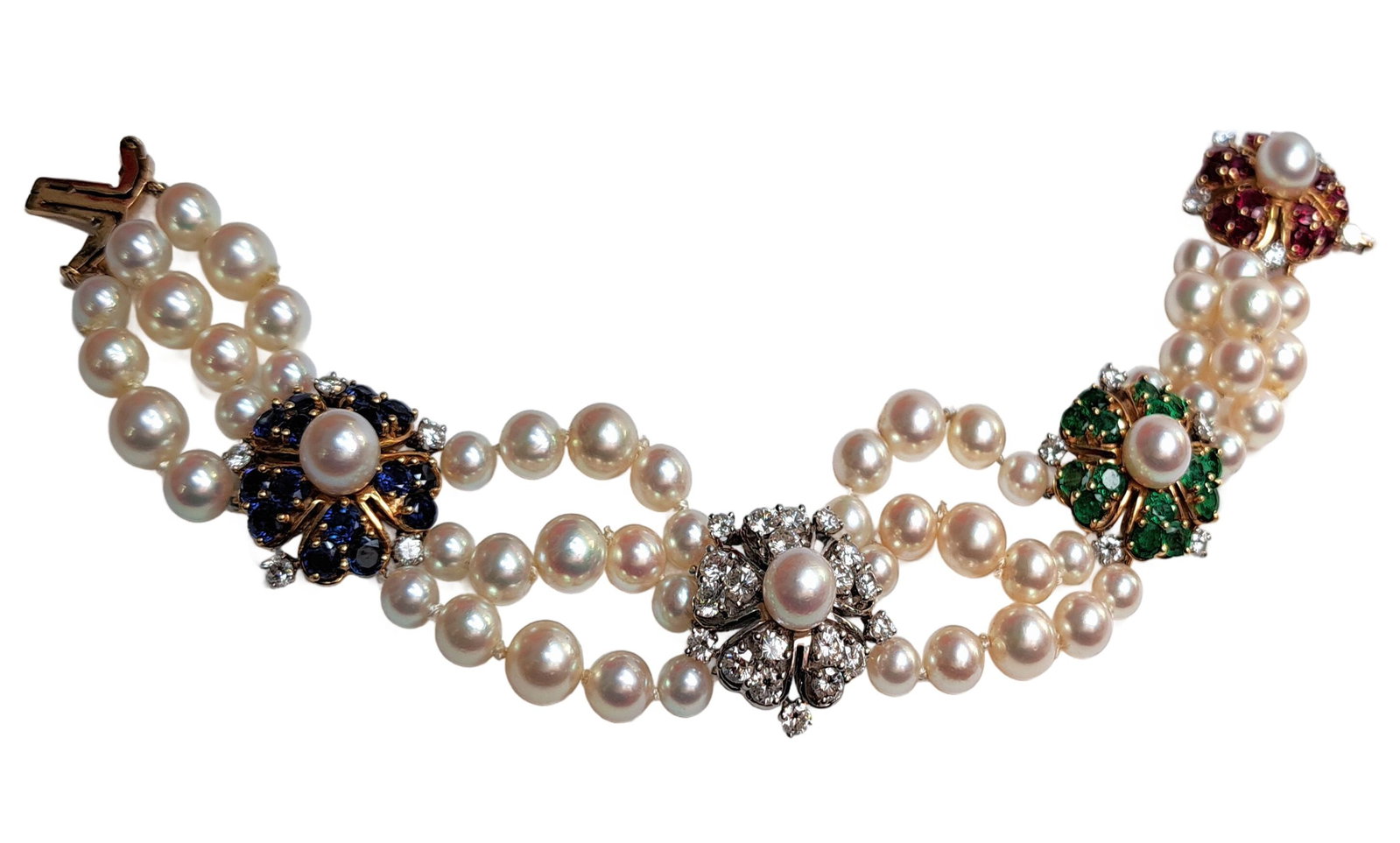 Long 1950s Van Cleef Arpels Stylized Flower Head Pearl Diamond Sapphire Emerald Ruby Flower 18k Gold: CNX 0504 1813 Described By: AF. ND Title: Long 1950s Van Cleef Arpels Stylized Flower Head Pearl Diamond Sapphire Emerald Ruby Flower 18k Gold Bracelet Description: Each station is composed of five co
