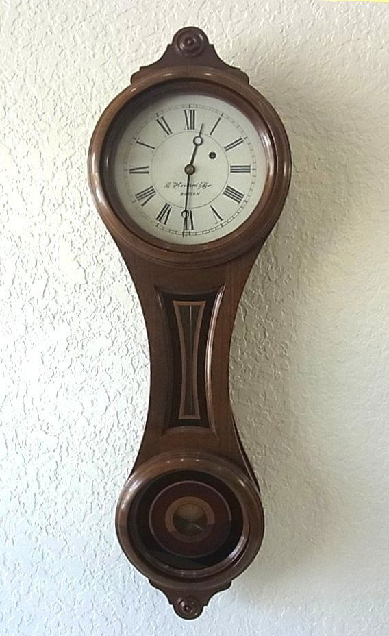 1976 E. Howard Anniversary Banjo Figure-eight Wall Cloc: 1976 E. Howard Anniversary Banjo Figure-eight Wall Clock No. 10 Boston, Massachusetts, Reissued example with walnut case, black, gold, and maroon glasses, painted iron dial marked E. Howard & Co. This