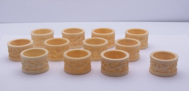 Set of 12 Antique Relief Carved Chinese Ivory Dragon Mo: Set of 12 Antique Relief Carved Chinese Ivory Dragon Motif with Black Inked Eyes Napkin Rings. Sprawling Dragon Motif Encircling Each piece from an ornamental center disk. Approximate Dimensions: 1 3/