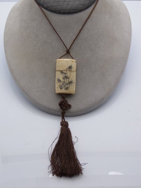 Vintage Mid Century or Earlier Carved Bone Vinaigrette: Vintage Mid Century or Earlier Carved Bone Vinaigrette Slide Pendant Tassel Necklace with Inked Floral Engraving. We believe this design to be a capsule for holding something aromatic or opium or othe