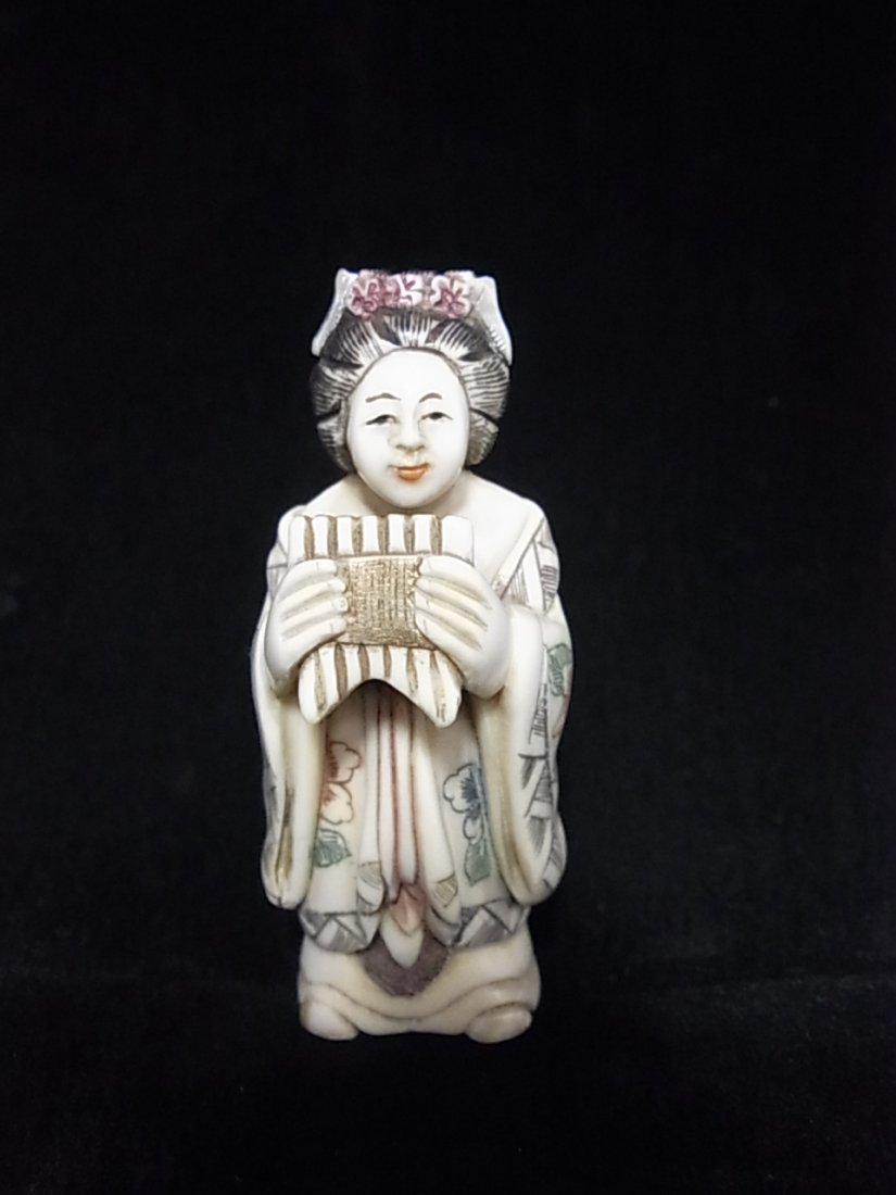 Antique Japanese Signed Ivory Netsuke Geisha Playing Ba: Antique Japanese Signed Ivory Netsuke Geisha Playing Bamboo Pan Flute Polychrome Inked Lotus Brocade Size: Approx 2-1/4 “ tall X 15/16 “ wide Hess Fine Auctions Shipping:We offer in house shippin