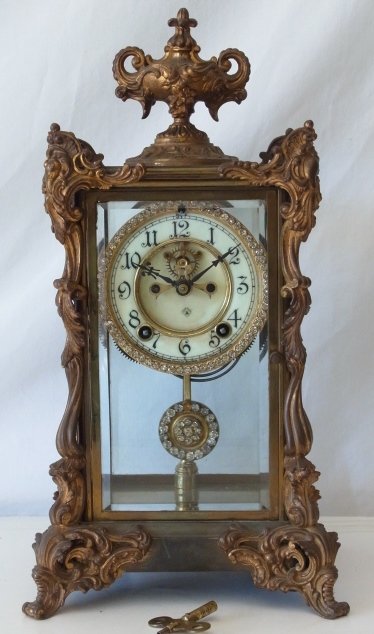 Ansonia Antique Tall Rhinestone Running Mantel Clock wi: Ansonia Antique Tall Rhinestone Running Mantel Clock with Key SIZE: 8” wide, 15¼” tall, 7 1/2” deep Hess Fine Auctions Shipping:We offer in house shipping for a handling fee, or you may elect t