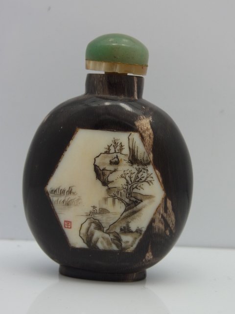 Asian Signed Carved Hoof Snuff Bottle: Asian Signed Carved Hoof Snuff Bottle. I believe the spoon attached to cap is carved bone and the topis jade or quartz. Size: 43mm wide, 25mm deep, 57mm tall Hess Fine Auctions Shipping:We offer in ho