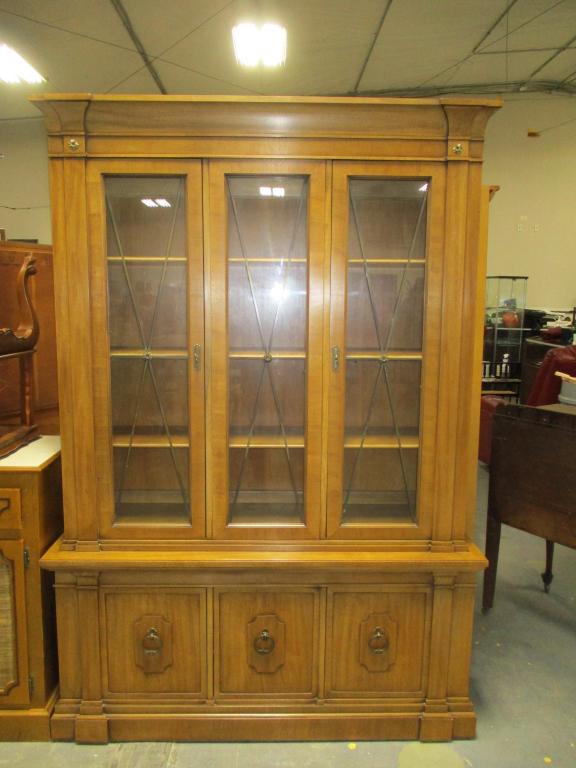 Thomasville Wood & Glass China Cabinet: Mid twentieth century. Upper two doors have glass to reveal 4 shelves for displaying items. Bottom has 3 doors with one of them having drawers for silverware. Marked "Thomasville Furniture Industries,