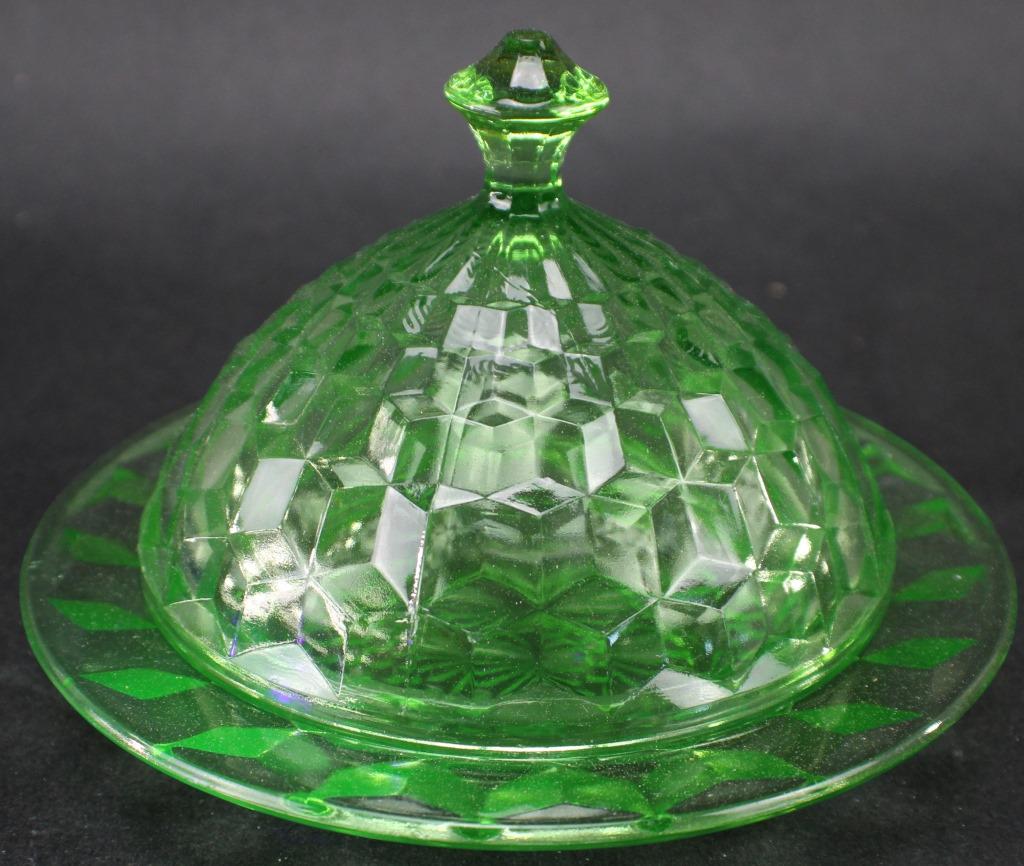 VINTAGE URANIUM GLASS COVERED ROUND BUTTER DISH: VINTAGE GREEN URANIUM GLASS COVERED ROUND BUTTER DISH. Measures approximately 6 3/8 Inches Diameter x 4 5/8 Inches Tall. Fluorescence under Blacklight. No visible chips or cracks. From the Witt Estate