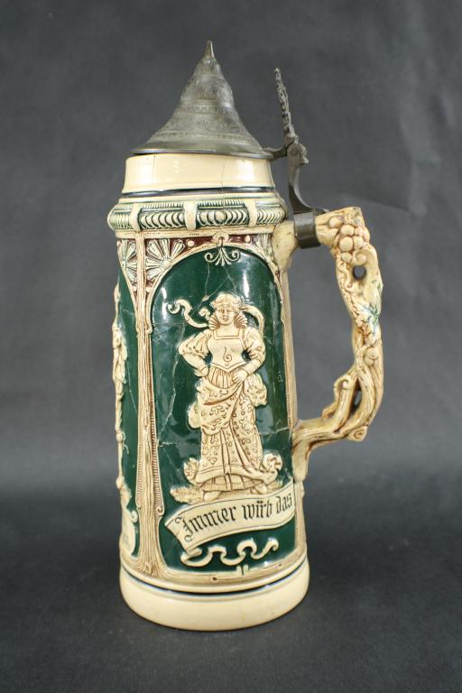 Antique German Matthias Girmscheid Beer Stein: Antique German Ceramic and Pewter Beer Stein, mold X33 Lovers, pottery relief with pewter lid, in blue, white, red, and brown. The bottom is marked "Germany" "O" The relief depicts a maiden and a land