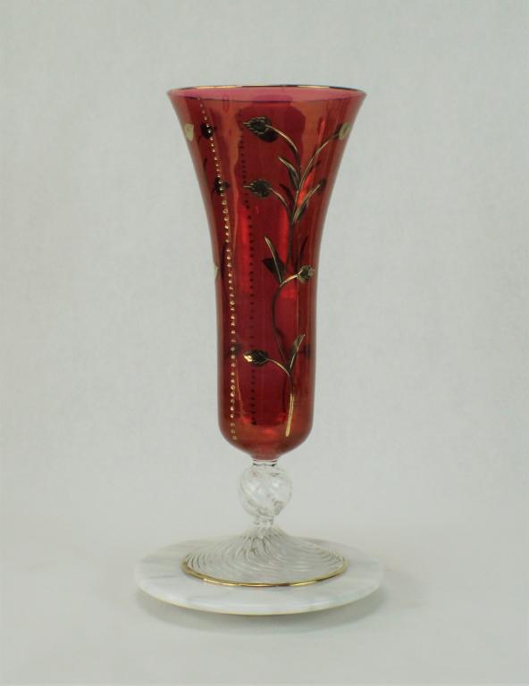 Ruby Red and Fired Gold Glass Vase: Clear ruby red Euro glass with 14K Yellow gold accents. Vine and leaf design. Has Marble turntable Base. Vase measures approximately 13 1/8 inches tall x 5 1/4 inches diameter at top of rim. No visibl