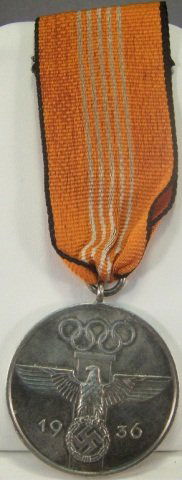 German WWII 1936 Berlin Olympics Decoration: German WWII 1936 Berlin Olympics Decoration. Includes the issue ribbon. Also included is a 1936 Berlin Olympics Film Maker Badge. Pin back. Maker marked 'Rob Neff Berlin 57'. Brass & enamel constructi
