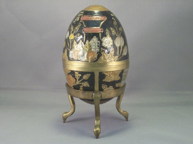 Vintage Ciosonne Decorative Brass Egg: Hand-painted brass egg w/ brass stand. Stand marked Made in India." Egg separates into two parts. Very good condition. 6 3/4" tall, 3 1/2" diameter. Very good condition."