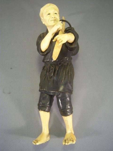 Vintage Ivory and Bronze Statue of Man with Paddle: Vintage Ivory and Bronze Statue of Man with Paddle - Piece has Repairs to Feet, Cracks in Legs and Missing Fingers - 8 x 2 1/4" x 6 1/2""