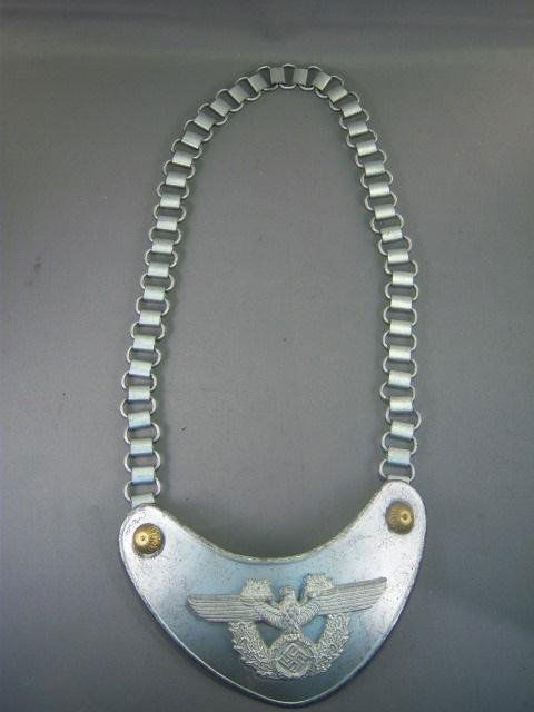German World War II Police Gorget With Neck Chain: German World War II Police Gorget With Neck Chain. Maker marked 'A' for Assmann. Has a grey wool backing