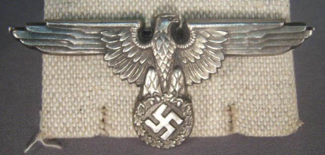 German WWII Waffen SS Officers Visor Cap Eagle: German World War II Waffen SS Officers Visor Cap Eagle. Maker marked 'SS 360/44 RZM'. Has two flat prongs on the reverse side. Stamped construction
